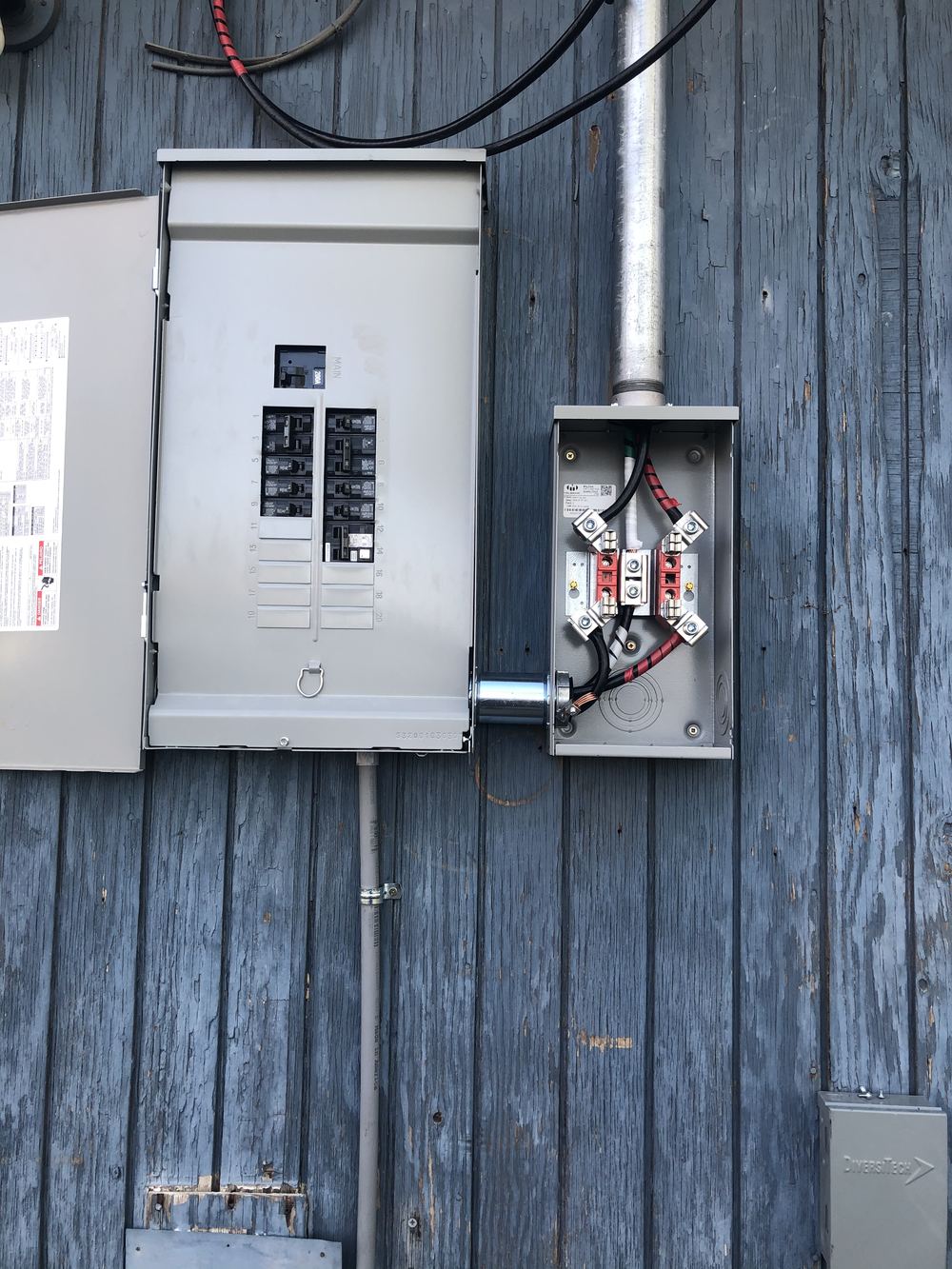 New 200 amp electrical panel and meter base installed on home exterior
